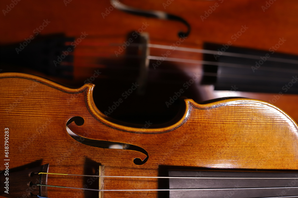 Fototapeta premium Cello's and violin's antique body closeup. String instruments.