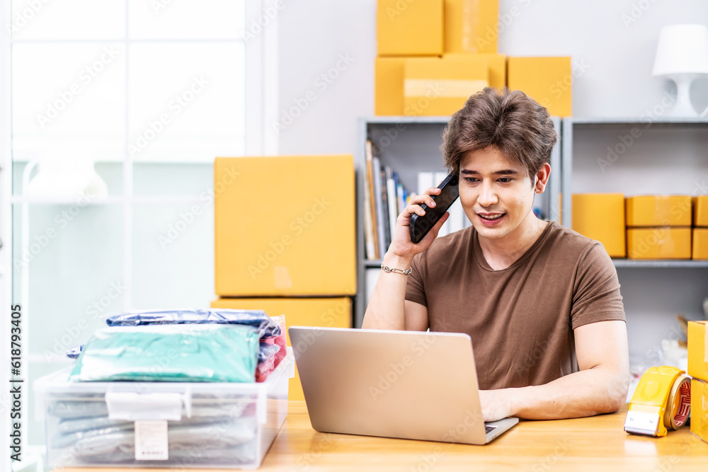 Startup small business entrepreneur SME, asian man receive order on phone. Portrait young Asian small business owner home office, packing boxes, SME sellers, e-commerce team, online sales Startup small business entrepreneur SME, asian man receive order on phone. Portrait young Asian small business owner home office, packing boxes, SME sellers, e-commerce team, online sales