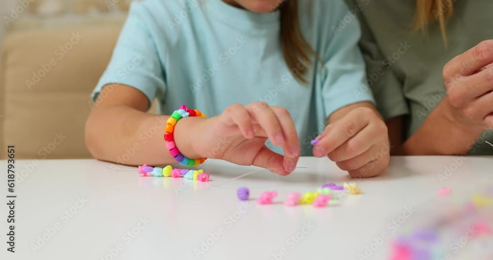 Process of making a bracelet from a thread and colored beads Process of making a bracelet from a thread and colored beads