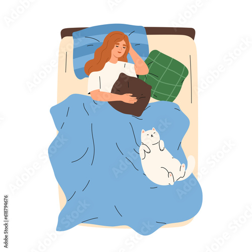 Woman sleeping in bed with cute cat asleep and lying together with her.