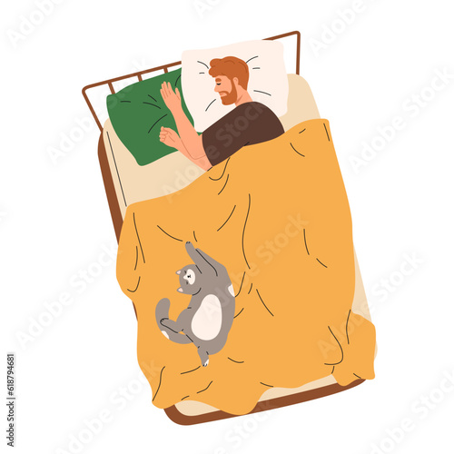Happy man sleeping in bed with cute cat asleep and lying together with him.