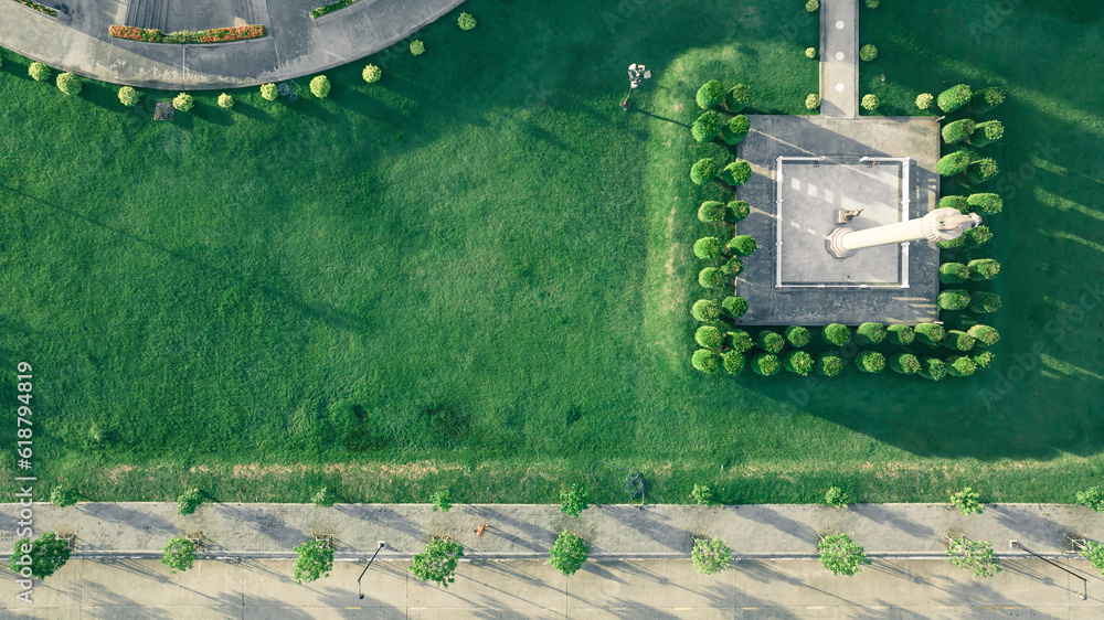Top view aerial photo from a flying drone of a city park buddha park with a walking path and green zone trees