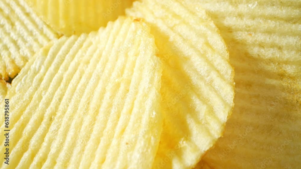 Macro video showcasing wavy potato chips with a probe lens captures intricate textures and contours, revealing a tantalizingly crispy snack in mesmerizing detail. Potato chips background. 4K UHD
Macro video showcasing wavy potato chips with a probe lens captures intricate textures and contours, revealing a tantalizingly crispy snack in mesmerizing detail. Potato chips background. 4K UHD