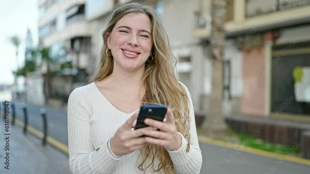 Young blonde woman smiling confident using smartphone at street Young blonde woman smiling confident using smartphone at street