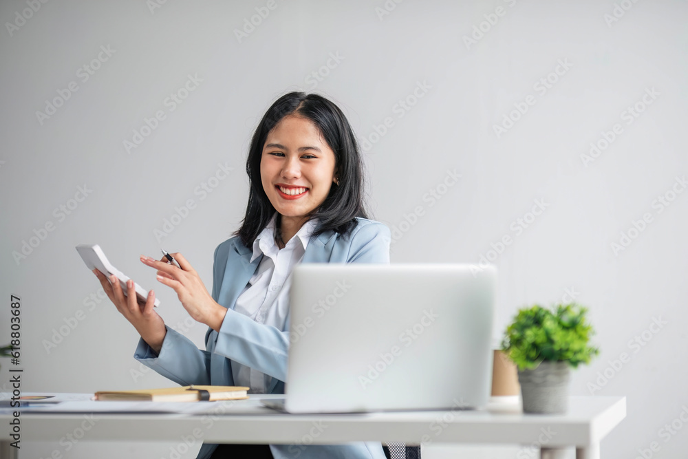 Business woman using calculator for do math finance on wooden desk in office and business working background, tax, accounting, statistics and analytic research concept.. Business woman using calculator for do math finance on wooden desk in office and business working background, tax, accounting, statistics and analytic research concept..