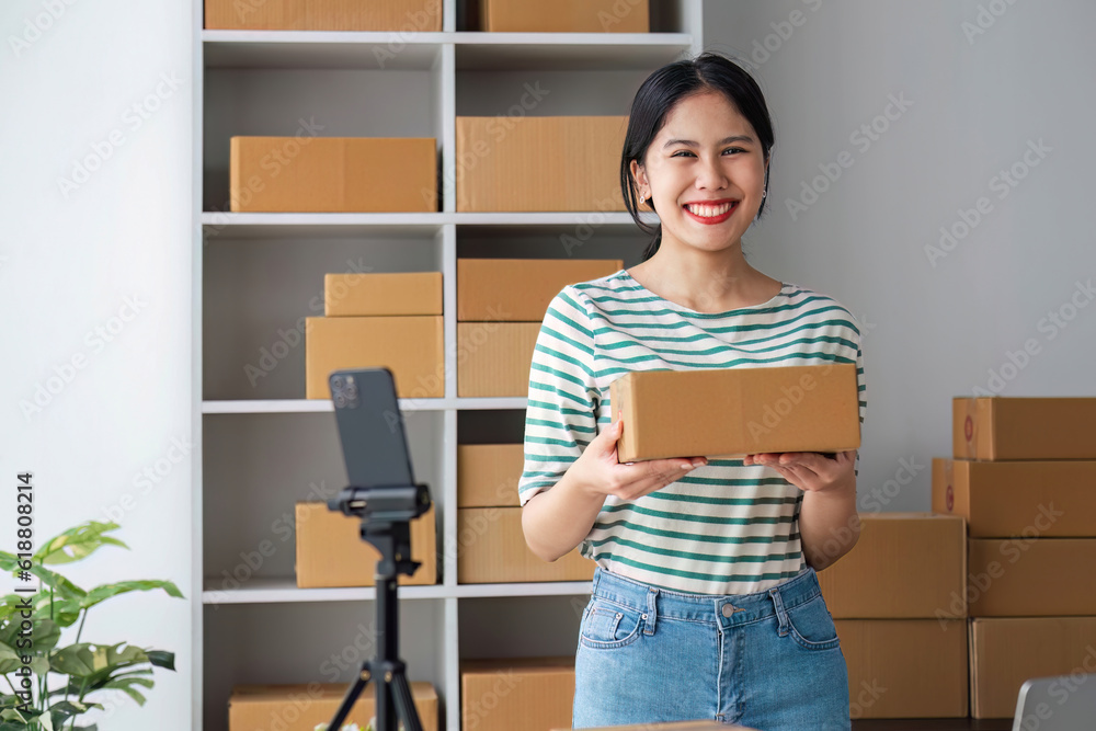 Starting Small business entrepreneur SME freelance, Portrait young woman working at home office, BOX, smartphone, laptop, online, marketing, packaging, delivery, b2b, SME, e-commerce concept.. Starting Small business entrepreneur SME freelance, Portrait young woman working at home office, BOX, smartphone, laptop, online, marketing, packaging, delivery, b2b, SME, e-commerce concept..