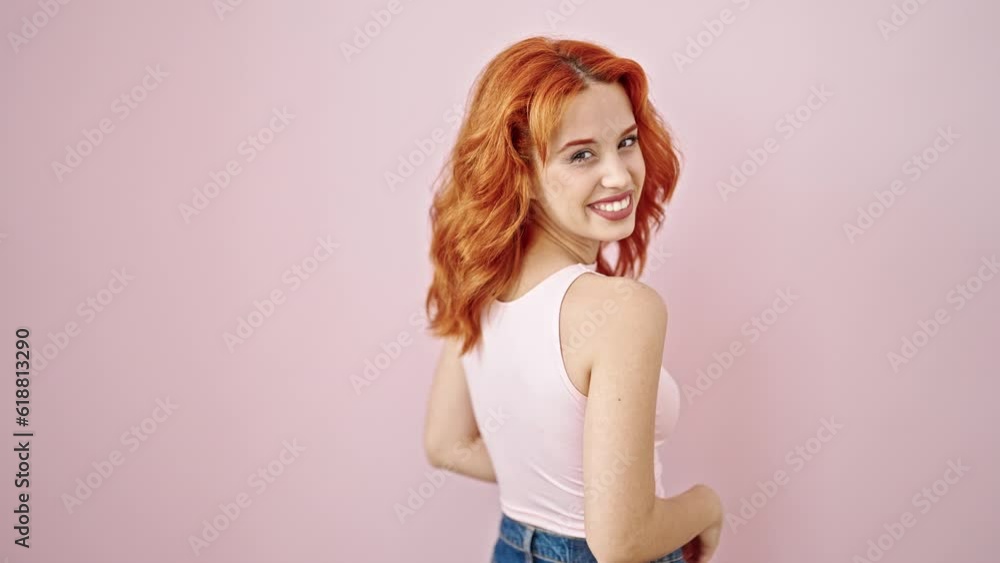 Young redhead woman smiling confident standing over isolated pink background Young redhead woman smiling confident standing over isolated pink background