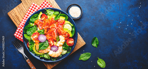 Obraz na płótnie Fresh salad for keto diet with salmon, avocado, spinach, cucumber, shrimps, tomato, cashew, sesame seeds