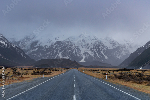 Scenic view along the Mount Cook Road alongside with snow capped Southern Alps basking in the late winter evening light. Best road trip route in New Zealand South Island with majestic Mount Cook. 