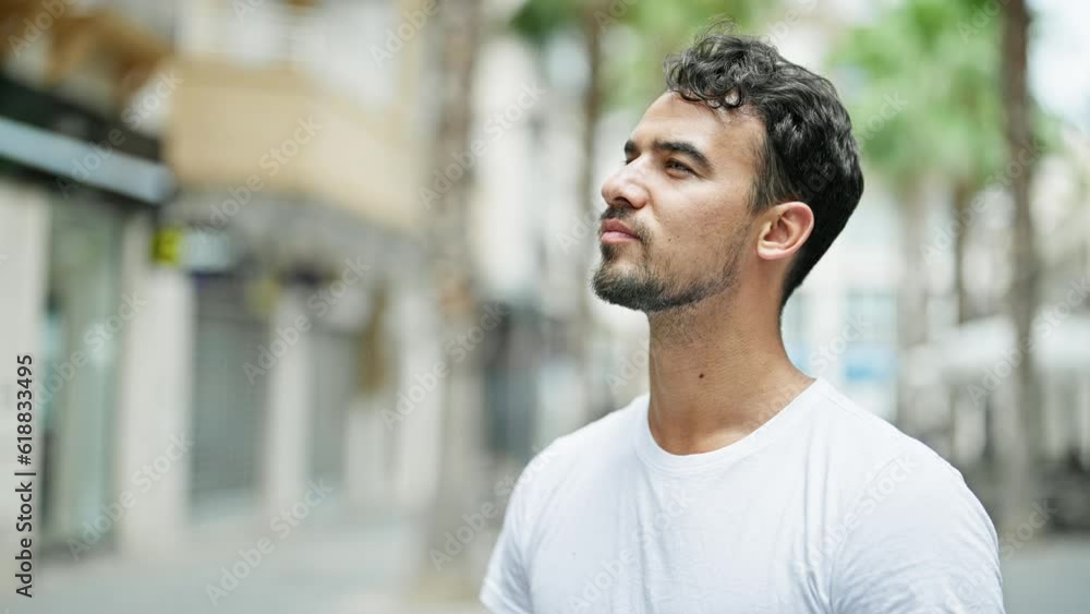 Young hispanic man sneezing at street Young hispanic man sneezing at street