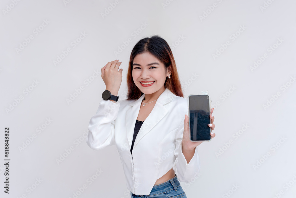 A smiling young woman posing in front of the camera with a smart phone while showing off her smart watch. Isolated on a white background. A smiling young woman posing in front of the camera with a smart phone while showing off her smart watch. Isolated on a white background.