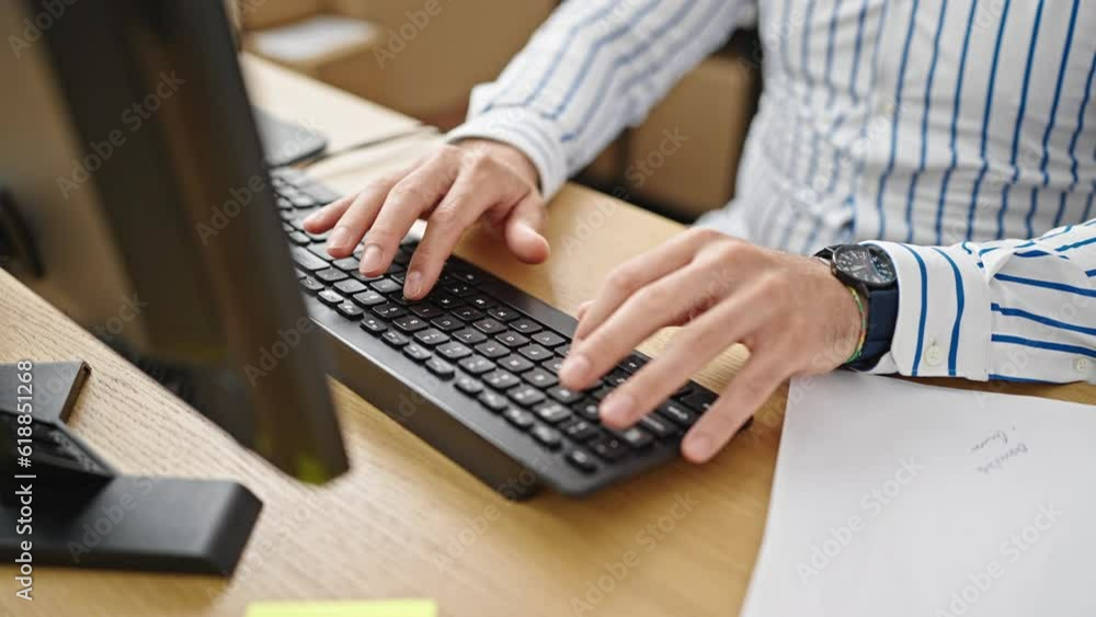 Young hispanic man ecommerce business worker using computer at office Young hispanic man ecommerce business worker using computer at office