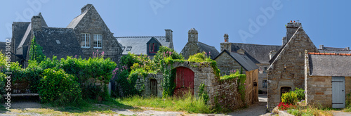 panoramic view of the center of the medieval village Locronan in Brittany with historic stone houses, France