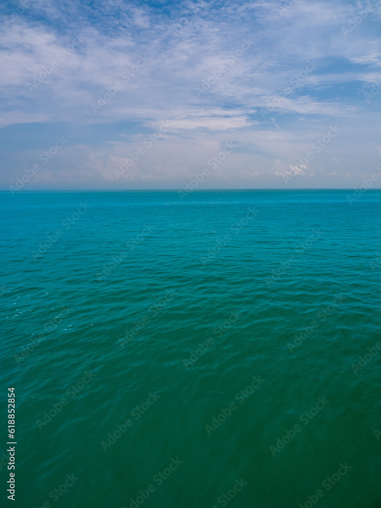 Obraz premium Vertical view Blue sea blue background look calm landscape viewpoint summer Nature tropical sea Beautiful ocean water Bangsaen Beach East thailand Chonburi Exotic horizon.
