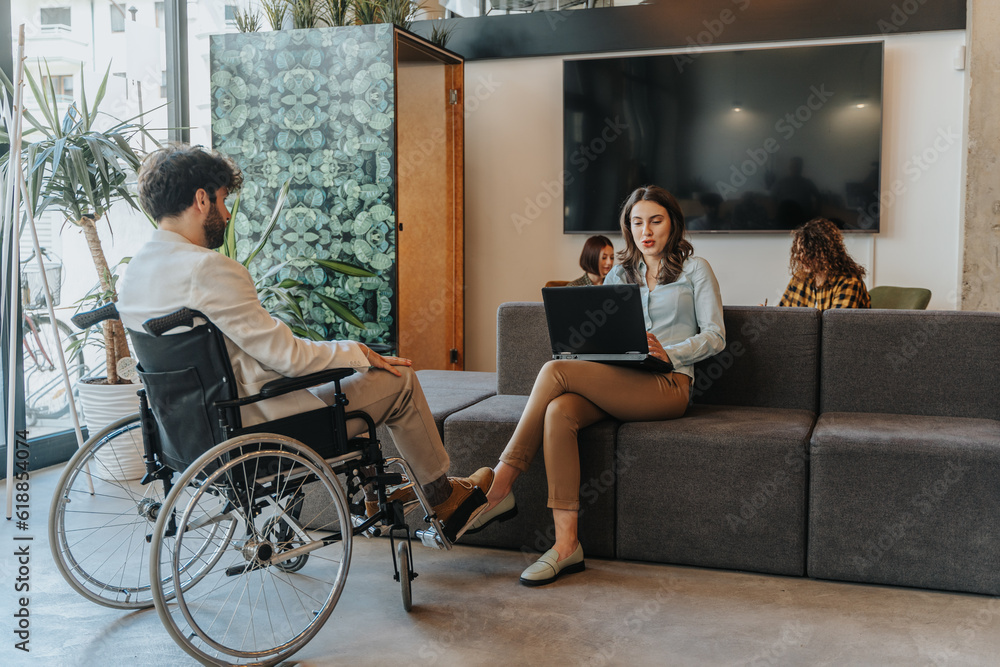 Man in a wheelchair and his female partner discussing potential opportunities and strategies for their next venture Man in a wheelchair and his female partner discussing potential opportunities and strategies for their next venture