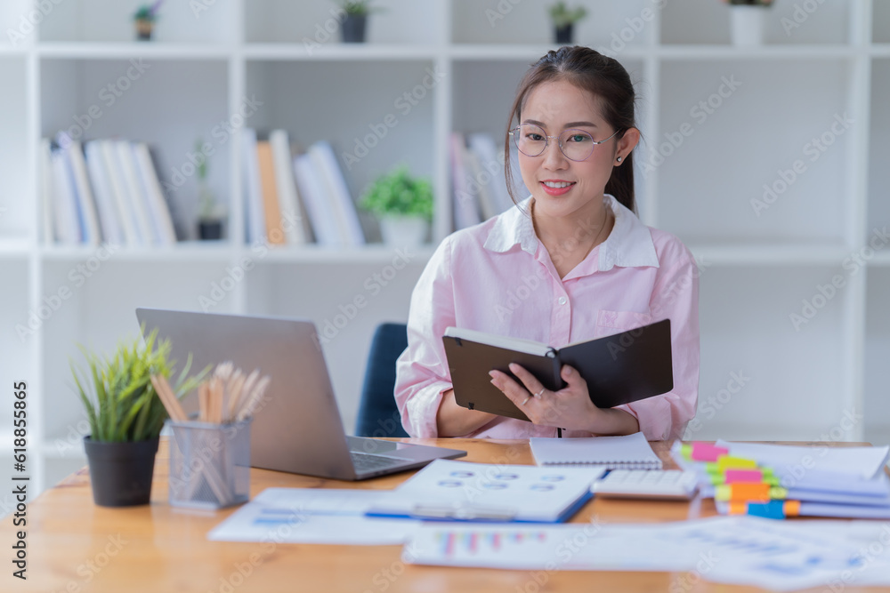 Sharing good business news. Attractive young businesswoman talking on the mobile phone and smiling while sitting at her working place in office. Sharing good business news. Attractive young businesswoman talking on the mobile phone and smiling while sitting at her working place in office.