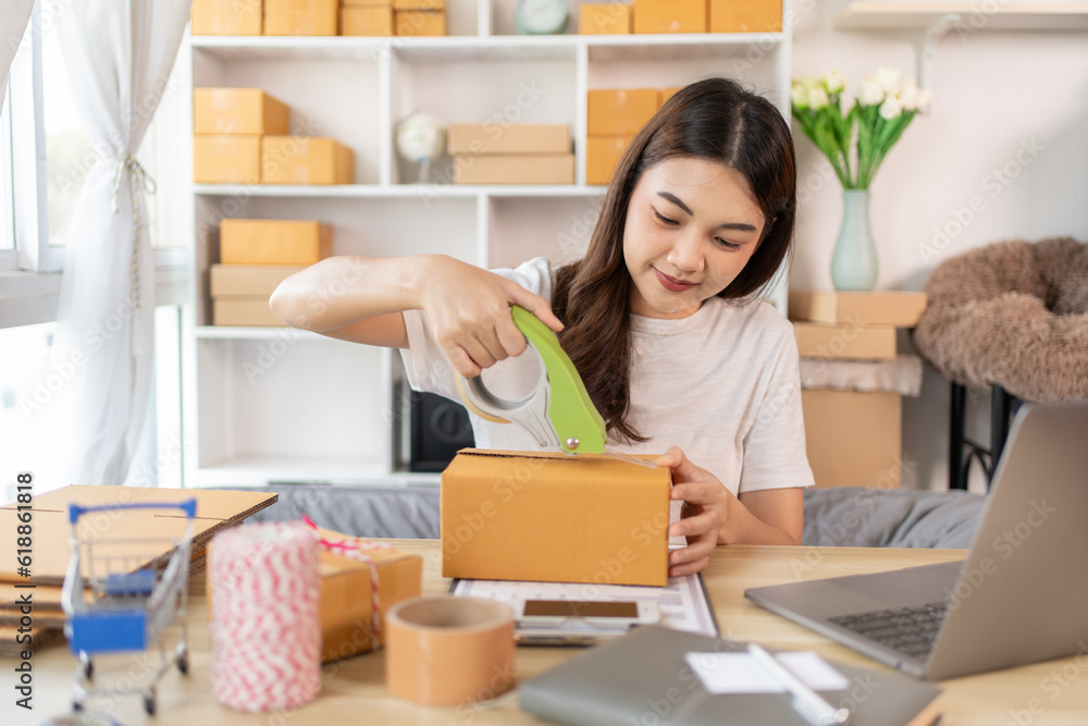 Efficient Home-Based Delivery, Woman Packing Items into Post Box for Customer Shipping, Online Shopping and Small Business Entrepreneurship, Packing box, Sell online, Freelance working. Efficient Home-Based Delivery, Woman Packing Items into Post Box for Customer Shipping, Online Shopping and Small Business Entrepreneurship, Packing box, Sell online, Freelance working.