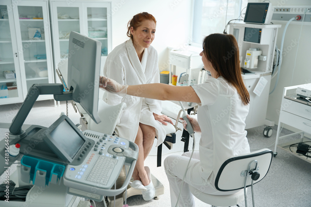 Obraz premium Doctor and female patient after transvaginal ultrasound examination