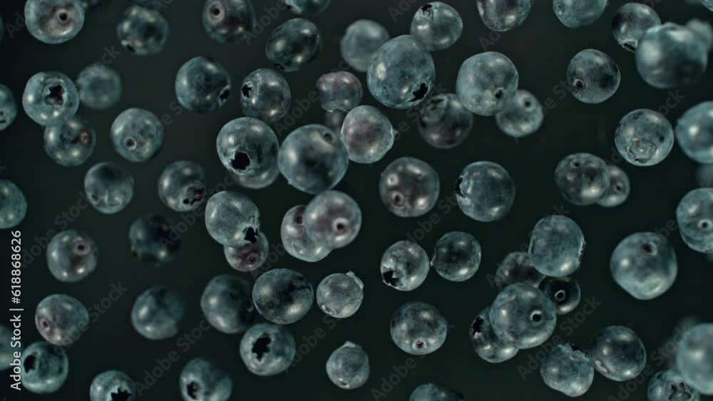 Super slow motion of rotating blueberries on black background, top view. Filmed on high speed cinema camera, 1000 fps, placed on high speed cine bot. Speed ramp effect. Super slow motion of rotating blueberries on black background, top view. Filmed on high speed cinema camera, 1000 fps, placed on high speed cine bot. Speed ramp effect.