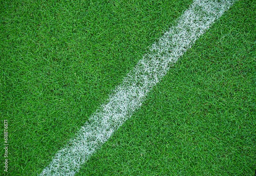 Top view of white stripes made on green grass at sports field. green grass for background or texture