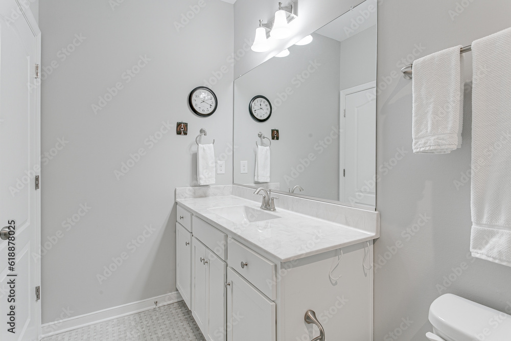 White minimal modern farmhouse residential traditional bathroom with marble countertops and large mirror professionally styled White minimal modern farmhouse residential traditional bathroom with marble countertops and large mirror professionally styled