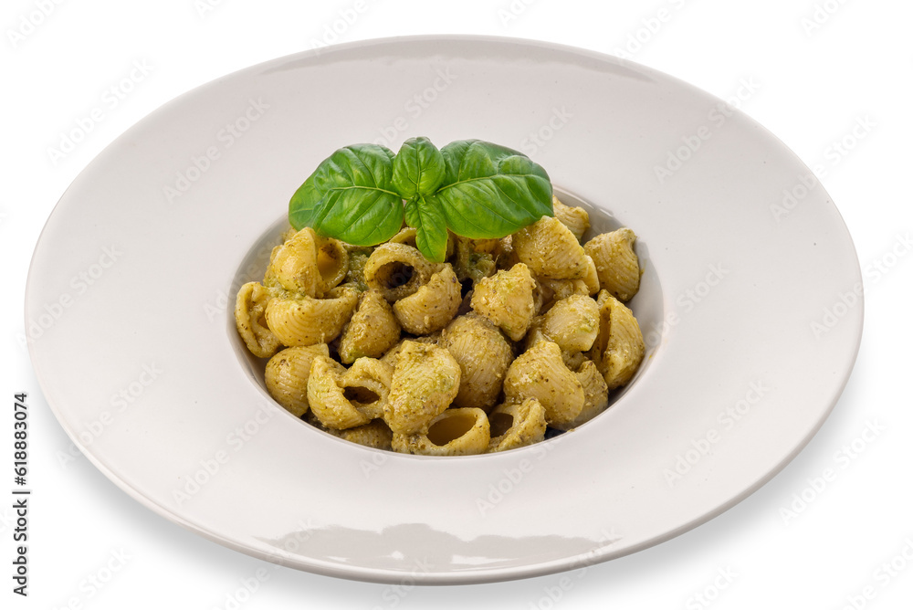 Macaroni pasta with pesto in a white dish with basil leaves, pesto is a typical Genoese sauce of basil, pine nuts, olive oil and parmesan cheese. Isolated on white with clipping path included. Macaroni pasta with pesto in a white dish with basil leaves, pesto is a typical Genoese sauce of basil, pine nuts, olive oil and parmesan cheese. Isolated on white with clipping path included.