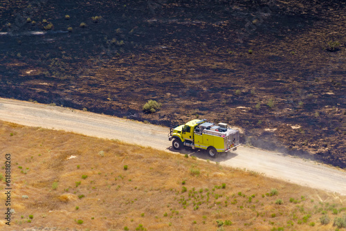 Wildland engine and crew engage in suppression activities on a vegetation fire