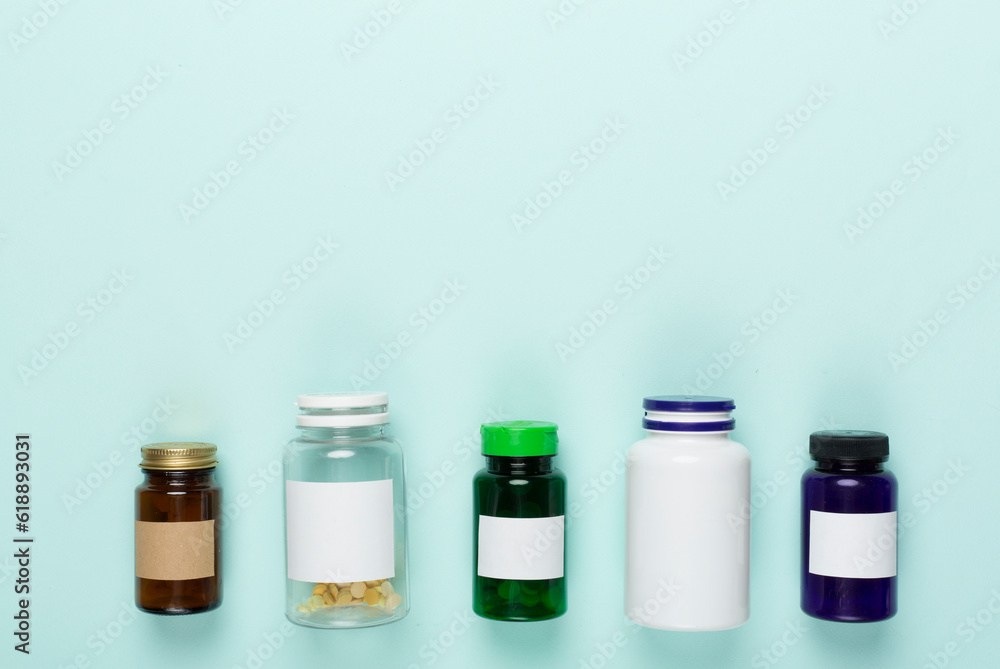 Plastic bottles with vitamins on color background, top view Plastic bottles with vitamins on color background, top view