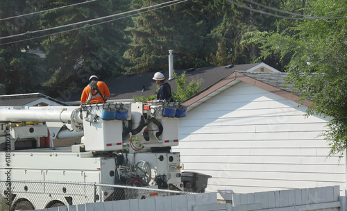 Two electricians on a truck crane