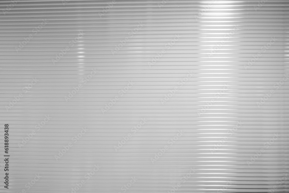 Fototapeta premium White Horizontal Plastic Striped Partition Background with Reflection of Light Beam.