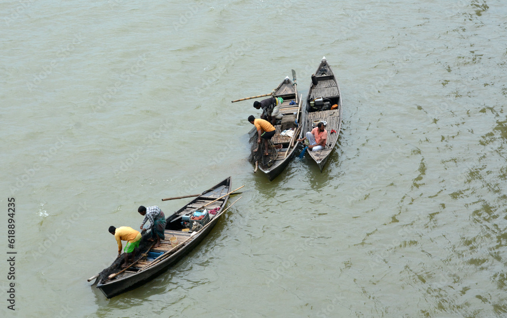 Fishermen are fishing in the river below Megna Bridge near in dhaka Bangladesh