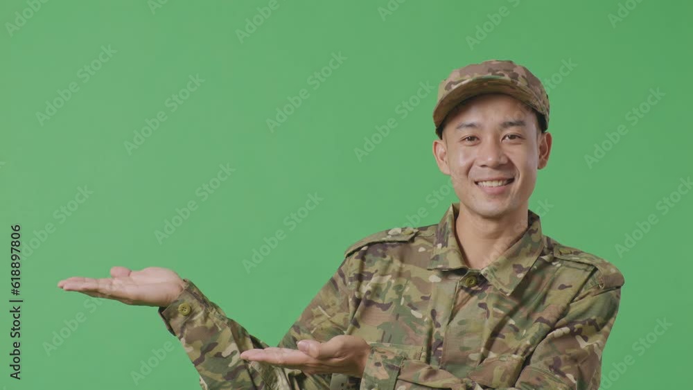 Close Up Of Asian Man Soldier Smiling And Pointing To Side While Standing In The Green Screen Background Studio
Close Up Of Asian Man Soldier Smiling And Pointing To Side While Standing In The Green Screen Background Studio