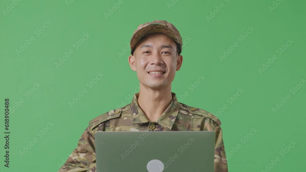 Close Up Of Asian Man Soldier Using A Laptop And Smiling While Standing In The Green Screen Background Studio
Close Up Of Asian Man Soldier Using A Laptop And Smiling While Standing In The Green Screen Background Studio