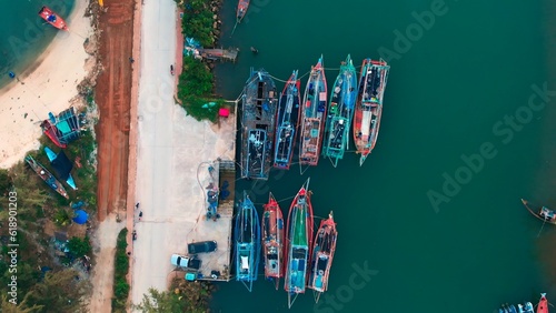 Aerial drone shot over the traditional wharf with moored boats in Indonesia. Aerial footage of top view traditional wharf on the Pacific coast. Traditional wharf on the coastline of the Indian Ocean.