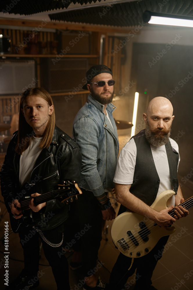 Rock band portrait with rockstar guitar player of different age Rock band portrait with rockstar guitar player of different age