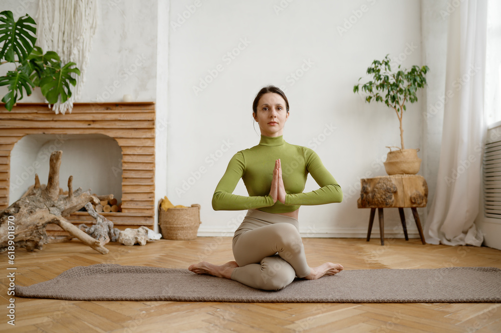 Portrait of attractive athlete woman practicing gomukhasana cow yoga pose Portrait of attractive athlete woman practicing gomukhasana cow yoga pose