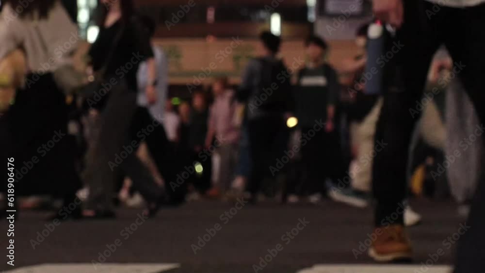 SHIBUYA, TOKYO, JAPAN - JUNE 2023 : Time lapse shot of crowd of people walking at Shibuya crossing at night. Busy downtown area in Tokyo. Japanese people, urban city life and traffic concept 4K video. SHIBUYA, TOKYO, JAPAN - JUNE 2023 : Time lapse shot of crowd of people walking at Shibuya crossing at night. Busy downtown area in Tokyo. Japanese people, urban city life and traffic concept 4K video.