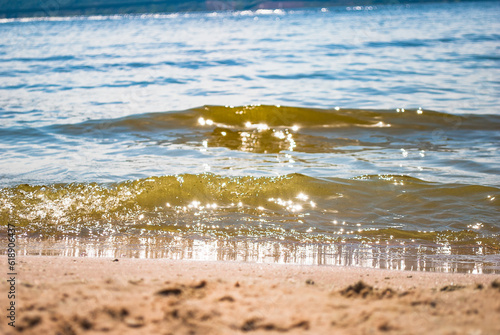 Sparkling silver waves in the sand. Summer beach background with a space for text. photo