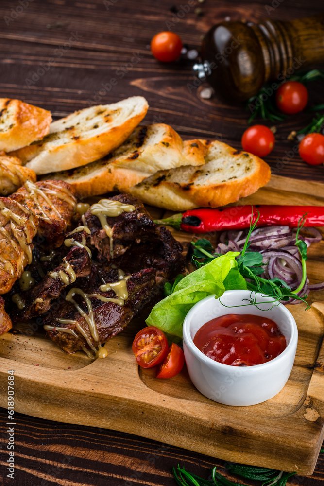 Snacks chicken, beef and pork fillet with potato wedges, onions, lettuce, chili peppers, cherry tomatoes and sauce. Snacks chicken, beef and pork fillet with potato wedges, onions, lettuce, chili peppers, cherry tomatoes and sauce.