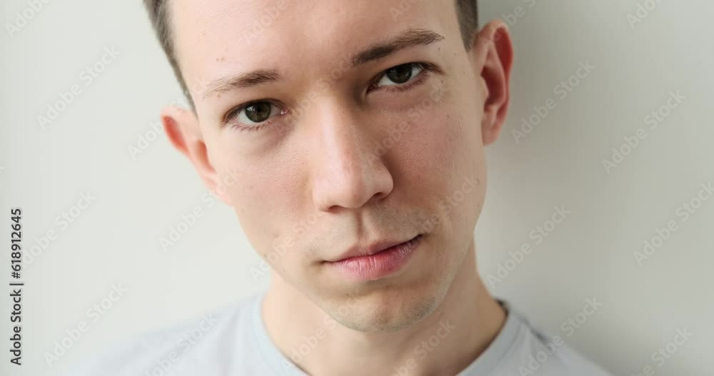 A charming Caucasian man stands against a pristine white background, looking directly into the camera with a warm and genuine smile. His eyes radiate joy and positivity. A charming Caucasian man stands against a pristine white background, looking directly into the camera with a warm and genuine smile. His eyes radiate joy and positivity.