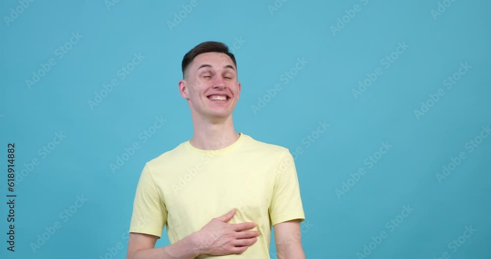 A jovial Caucasian man on the blue background bursts into laughter, unable to contain his infectious sense of humor. His eyes crinkle with mirth, and his mouth forms a wide. A jovial Caucasian man on the blue background bursts into laughter, unable to contain his infectious sense of humor. His eyes crinkle with mirth, and his mouth forms a wide.