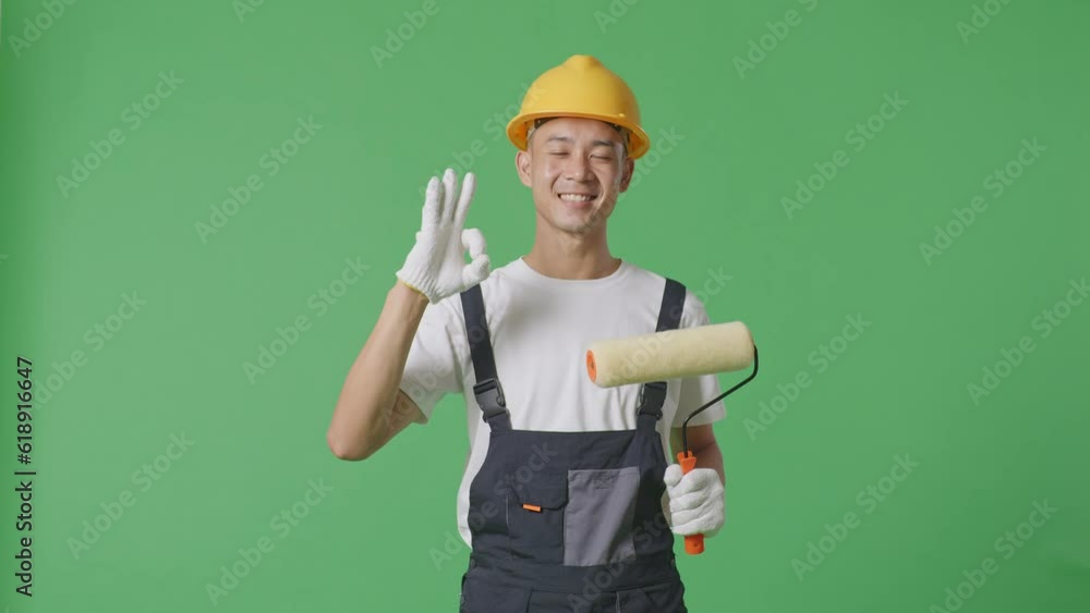 Asian Man Painter Wearing Safety Helmet Smiling And Showing Okay Gesture To Camera While Standing In The Green Screen Background Studio
Asian Man Painter Wearing Safety Helmet Smiling And Showing Okay Gesture To Camera While Standing In The Green Screen Background Studio
