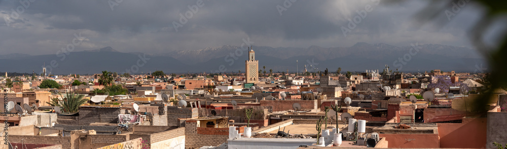 Scenic view of the Marrakech medina and the Atlas mountains in the background during stormy weather