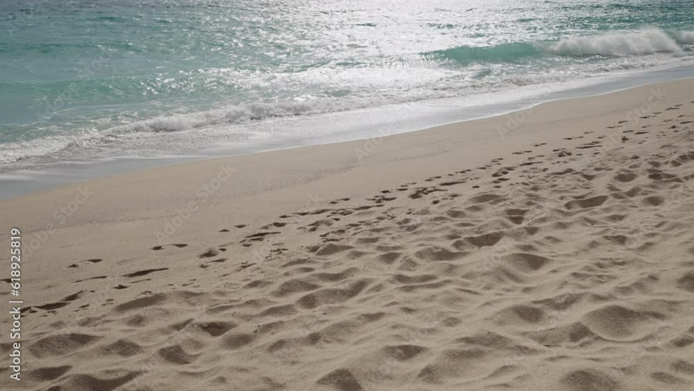 Slow motion clear blue waves with strong wind on a sandy empty beach in Cannes in spring Slow motion clear blue waves with strong wind on a sandy empty beach in Cannes in spring