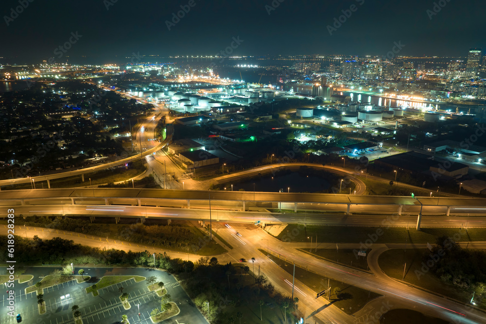 Above view of wide highway crossroads in Tampa, Florida at night with fast driving cars. USA transportation infrastructure concept