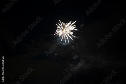 Aerial view of bright fireworks exploding with colorful lights against dark night sky on US Independence day holiday