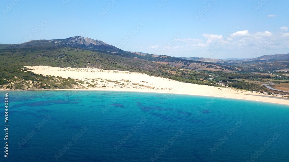 beautiful aerial view from the Atlantic towards the huge Dunes of Valdevaqueros with forest, mountains and rocks in the background, Tarifa, Andalusia, province of Cádiz, Spain