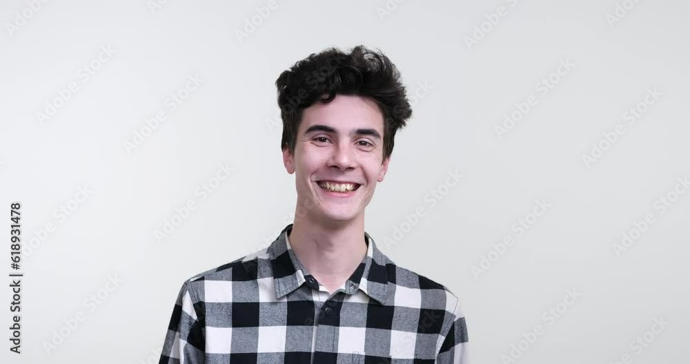 A charismatic curly-haired Caucasian man on clean white background. His eyes sparkle, and a wide grin spreads across his face as he erupts into laughter. A charismatic curly-haired Caucasian man on clean white background. His eyes sparkle, and a wide grin spreads across his face as he erupts into laughter.