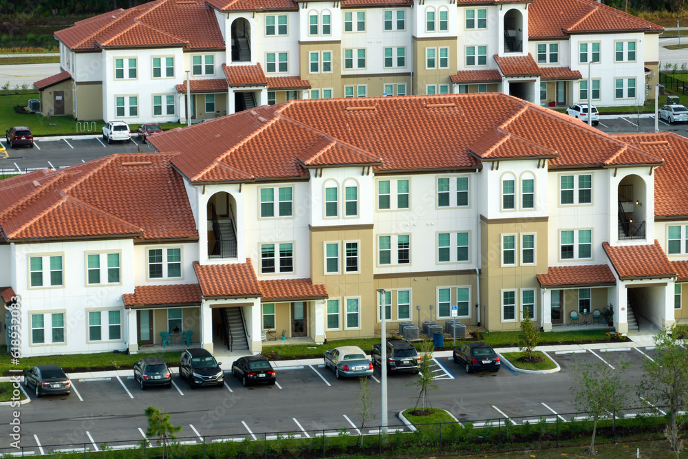View from above of apartment residential condos in Florida suburban area. American condominiums as example of real estate development in USA suburbs View from above of apartment residential condos in Florida suburban area. American condominiums as example of real estate development in USA suburbs