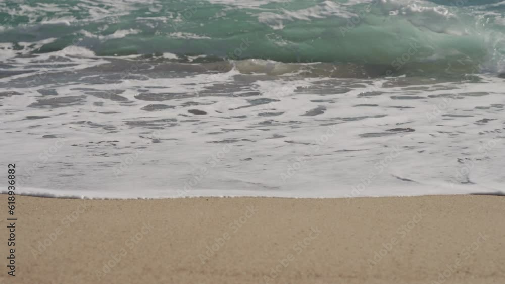 Slow motion clear blue waves with strong wind on a sandy empty beach in Cannes in spring Slow motion clear blue waves with strong wind on a sandy empty beach in Cannes in spring